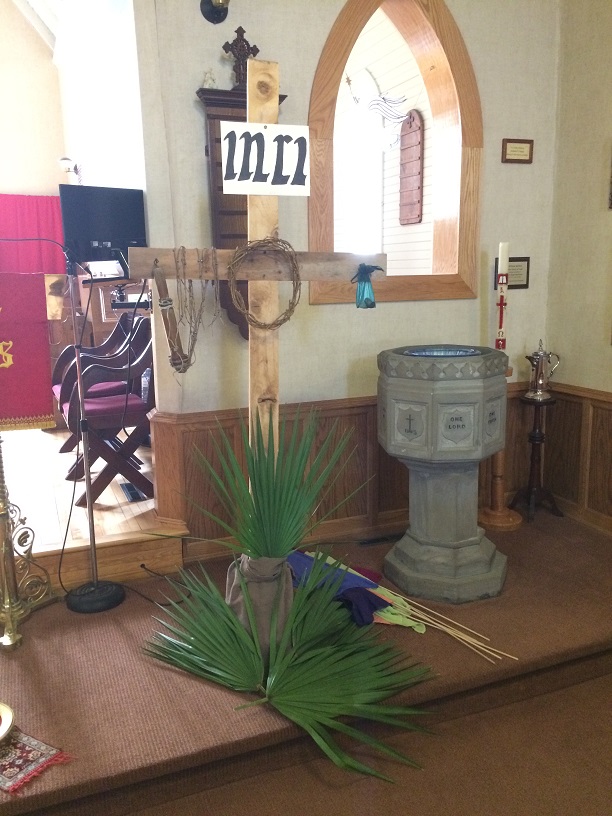 The Symbols of Lent - The palms are placed at the foot of the cross. Sixth Sunday in Lent, April 14, 2019.